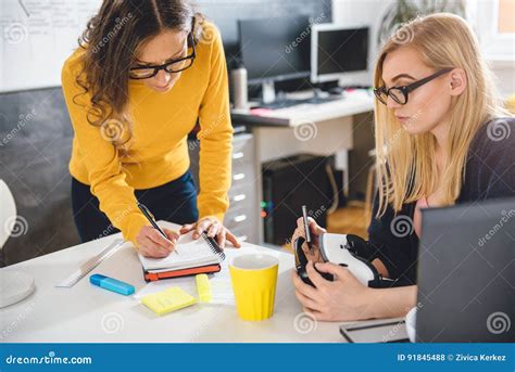 Two Business Woman Working Together At The Office Stock Photo Image