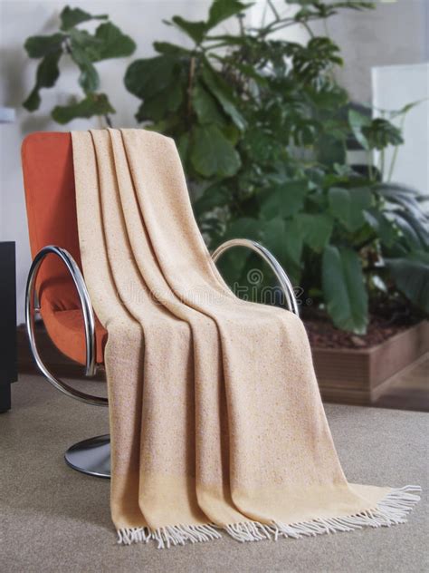 Here is how to properly use a chair. Throw draped over a chair stock image. Image of nobody ...