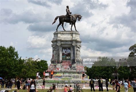Protesters Climb On The Base Of The Statue Of Confederate General