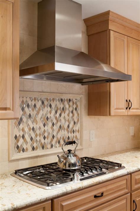 Kitchen With Diamond Shaped Tile Backsplash And Stainless Steel Range