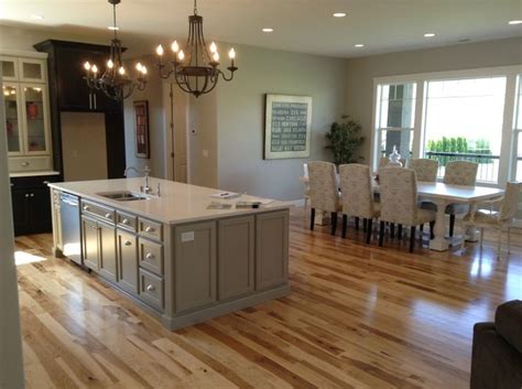Gray floors with hickory cabinets are dramatic and in vogue. White Quartz Kitchen Countertop with hickory wood floors ...