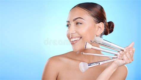 Black Woman Studio And Smile With Makeup Brushes In Hand For Face