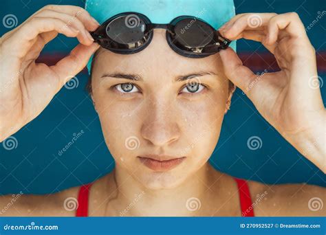 Extreme Close Up Shot Of A Caucasian Girl Head With A Swimming Cap And Hands Putting Swimming