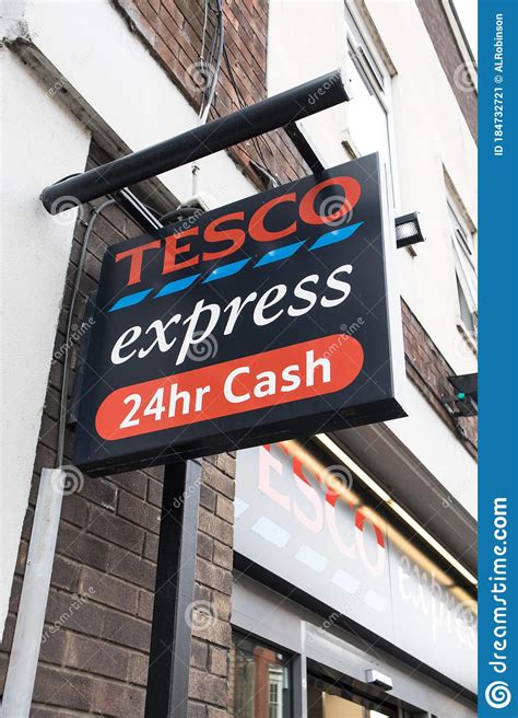 Exterior View Of Entrance To Tesco Express Supermarket Showing Sign