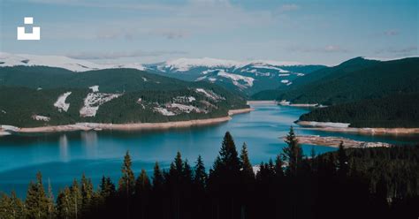 A Large Body Of Water Surrounded By Mountains Photo Free Lake Image