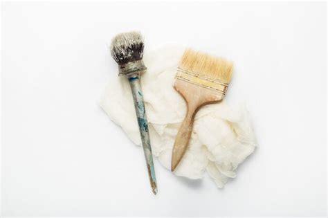 Premium Photo Paint Brushes And Rag On A White