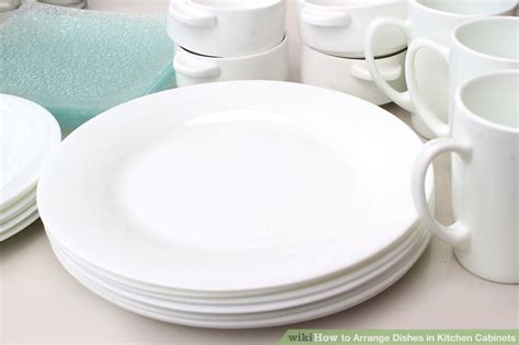 If you have fairly deep drawers, you can help keep your pots and pans organized by adding your own dividers. 4 Ways to Arrange Dishes in Kitchen Cabinets - wikiHow