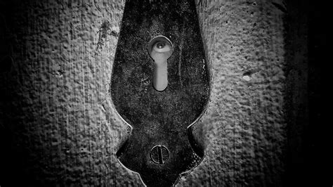 Male Eye Looking Around Through A Keyhole Of A Vintage Door Stock Video