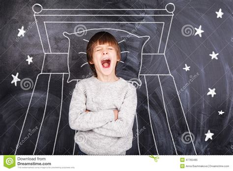 Boy Yawns And On The Background Of Painted Bed Stock Image Image Of