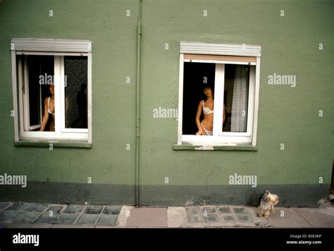 Prostitutes Dressed In Underwear Looking Out Of Windows Brothel Outside