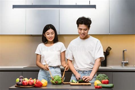 Chinese Couple Cooking Together In Kitchen Preparing Dinner On Weekend Stock Image Image Of