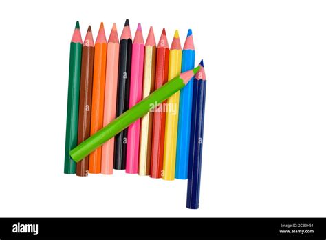 Green Colored Wood Pencil Crayon Placed On Top Of Many Different Color
