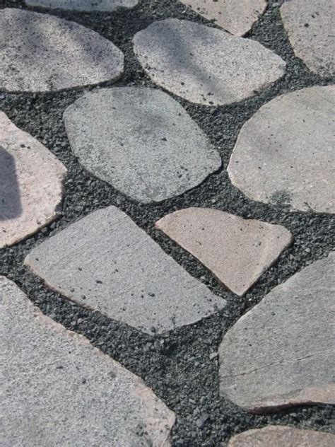 Top garden walkway installation service. RealStone Natural Stone stepping stones with black gravel ...
