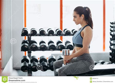 Beautiful Young Woman Exercising With Dumbbell In The Gym Stock Image