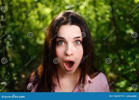 portrait of extremely surprised stunned woman with emotive open stock image