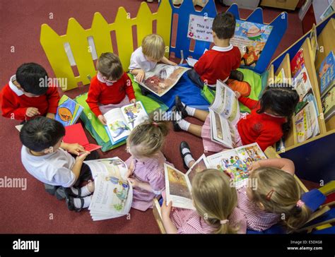 Primary School Children Reading In A Classroom In The Uk Stock Photo