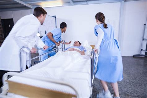 Doctors Standing Near Patient Bed Stock Image Image Of Care Group
