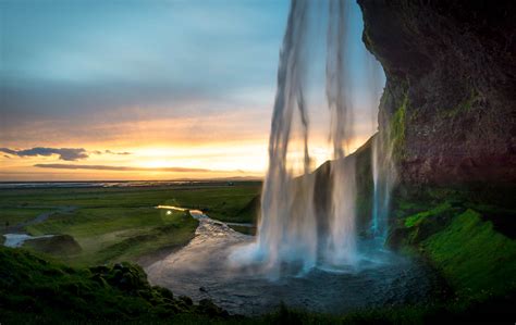 Seljalandsfoss Waterfall From Behind The Water Sunset Find Away