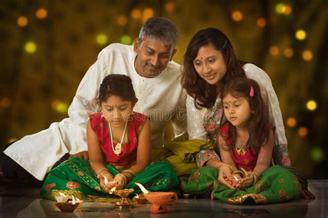 Although the festival itself originates in india, deepavali celebrations don't limit themselves to the country of their origin. Family celebrating Diwali stock image. Image of happy ...