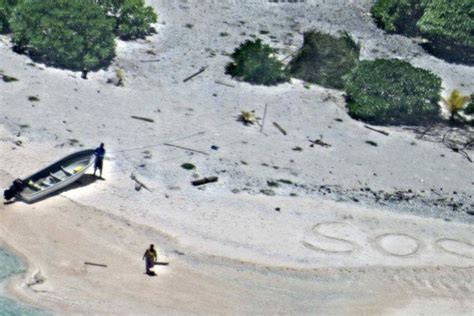 Couple Stranded On Desert Island Rescued After Writing Sos Message In Sand On Beach The