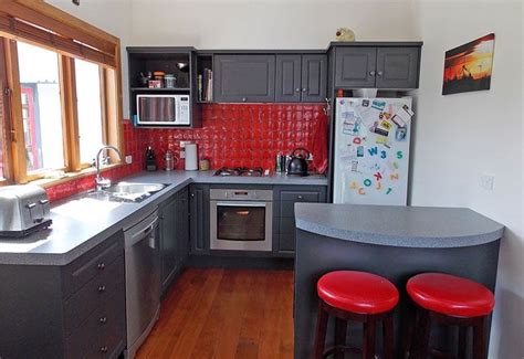 Black kitchen cabinets with red walls. Resene Island Spice on Kitchen walls | Small kitchen decor ...