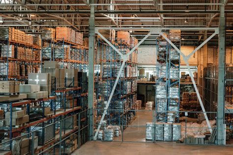 Modern Warehouse Interior With Boxes And Containers On Shelves Stock