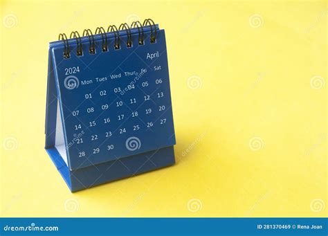 April 2023 Blue Desk Calendar On Yellow Cover Background With