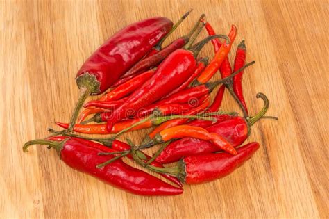 Two Varieties Of Dried Red Pepper Chili On Wooden Surface Stock Image