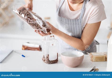 careful woman filling up a jar stock image image of meal dish 87618631