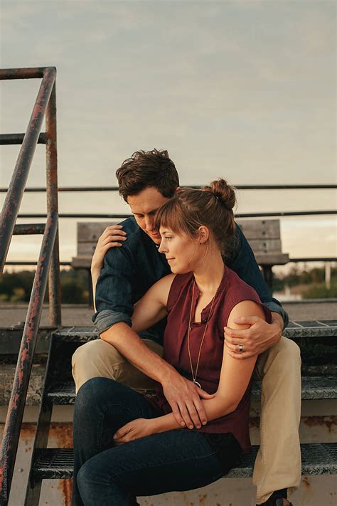 Couple Embracing With View Of Ocean At Sunset By Stocksy Contributor Luke Liable Stocksy