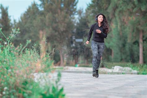Woman Running On The Path Of A Park Healthy Lifestyle Concept