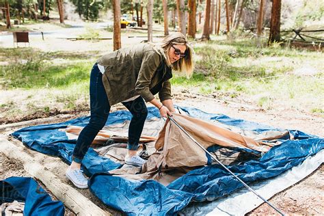 A Woman Pitching A Tent All By Herself Del Colaborador De Stocksy