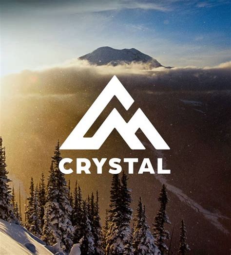The Logo For Crystal Is Shown On Top Of A Snowy Mountain With Pine Trees In The Foreground
