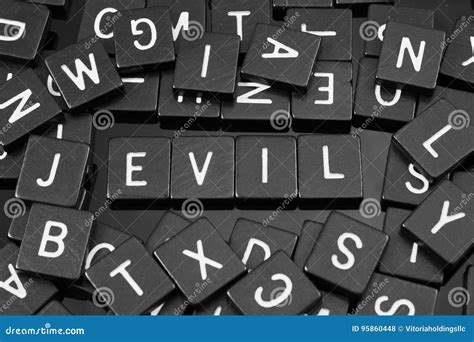 Black Letter Tiles Spelling The Word And X22eviland X22 Stock Photo