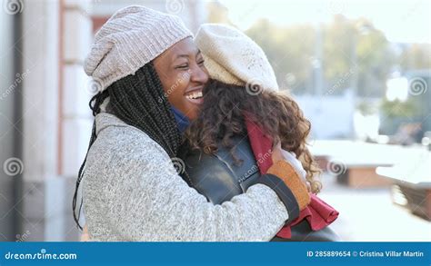 two multiracial female happy friends hugging each other on city street stock footage video of