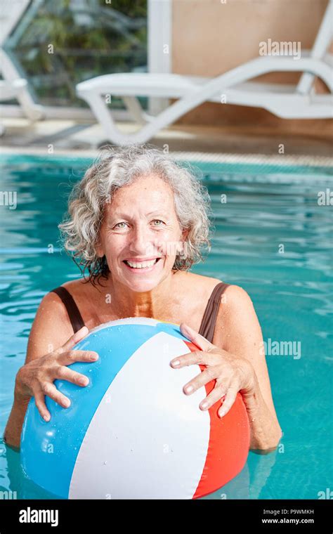 Old Lady In Swimsuit Relaxing By The Swimming Pool Stock Photo Download
