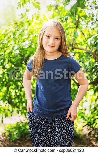 Portrait Of A Cute Little Girl Of 7 Years Old In The Park On A Sunny