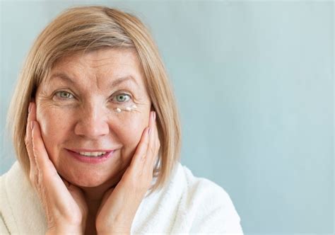 Premium Photo Portrait Of A Cheerful Mature Cheerful Woman Seniora With Anti Aging Cream