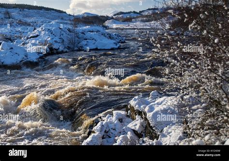 Scottish Highland River In Winter Spate From Snow Melt River Runs From