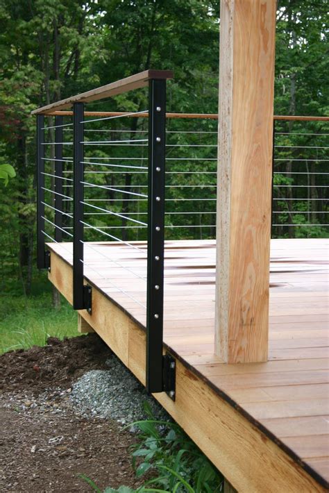 Browse our versatile railing systems. modern cabin: deck railing, metal railing posts, wire, wood | Deck railing design, Building a ...