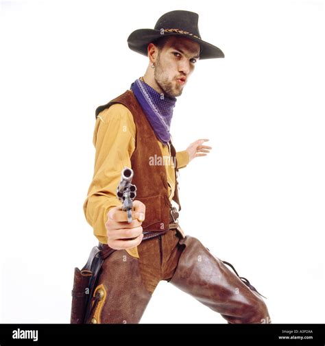 Young Man Dressed As Cowboy Pointing Gun Portrait Stock Photo