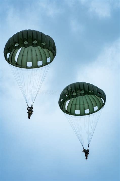 Vertical Shot Of Us Soldiers Parachuting During The D Day Reenactment