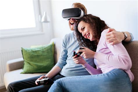 Young Couple Playing Games With Virtual Reality Headset Stock Photo