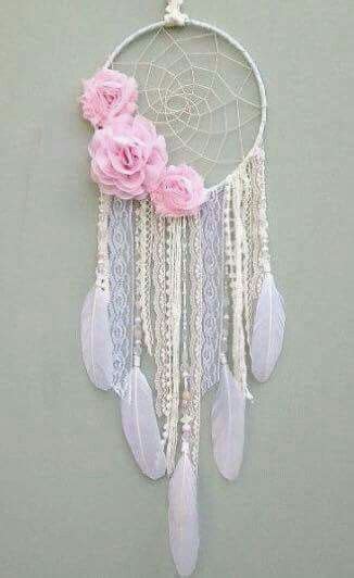 An Image Of A Dream Catcher With Pink Flowers On Its Side And The