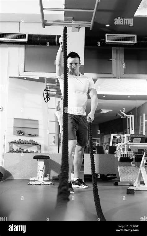 Young Man Working Out With Battle Ropes At A Gym Stock Photo Alamy