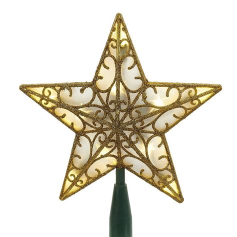 A Lighted Christmas Star On Top Of A Green Pole