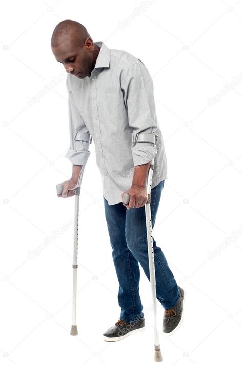 Man Walking With Crutches Stock Photo By ©stockyimages 68968567