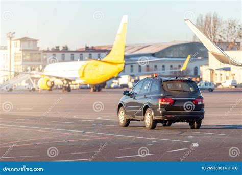 Scenic View Of Airport Security Car On Tarmac Apron Taxiway In Warm