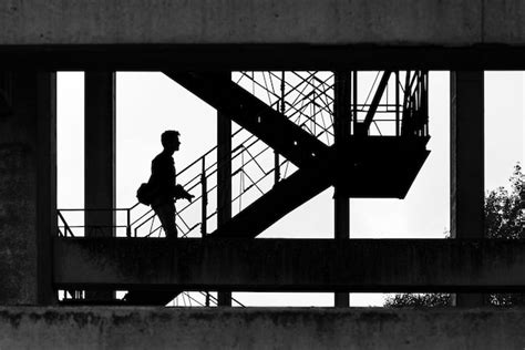 Premium Photo Scenic Black And White Shot Of A Silhouette Of A Man Walking Up On The Staircase
