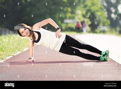 Girl Plank Sideways Outdoors Track Stock Photo Alamy